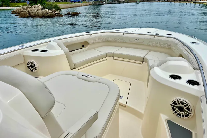  Yacht Photos Pics Luxurious seating area on 2026 Scout 288 LXF boat, featuring cup holders and speakers.