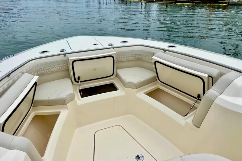  Yacht Photos Pics 2026 Scout 288 LXF boat interior with open storage compartments and cushioned seating.