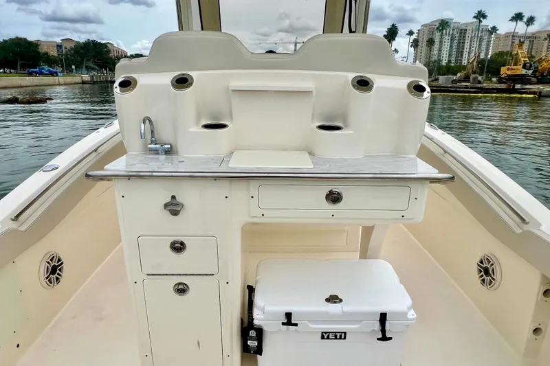  Yacht Photos Pics 2026 Scout 288 LXF boat interior with sink, storage, and Yeti cooler.