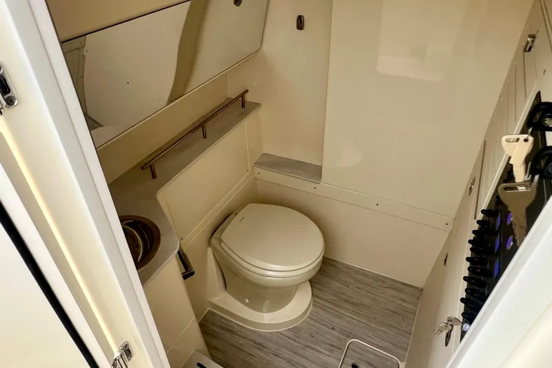  Yacht Photos Pics 2026 Scout 288 LXF boat bathroom with toilet and sink, featuring modern design.