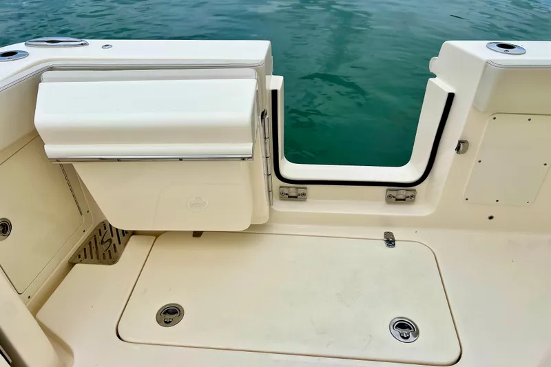  Yacht Photos Pics 2026 Scout 288 LXF boat deck with open transom door, near water.