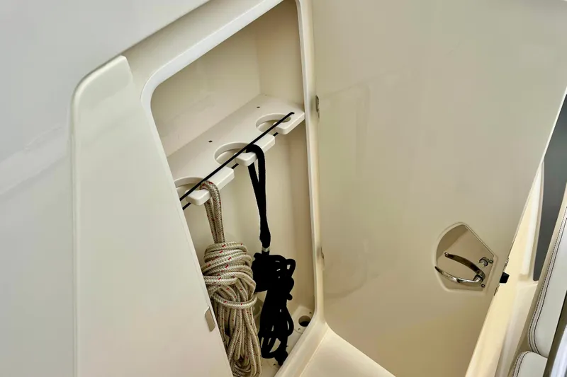  Yacht Photos Pics 2026 Scout 288 LXF boat storage compartment with ropes and secure latch.
