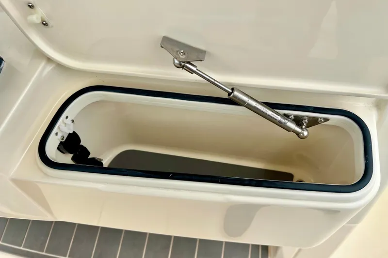  Yacht Photos Pics Open storage compartment on 2026 Scout 288 LXF boat, featuring hydraulic support.