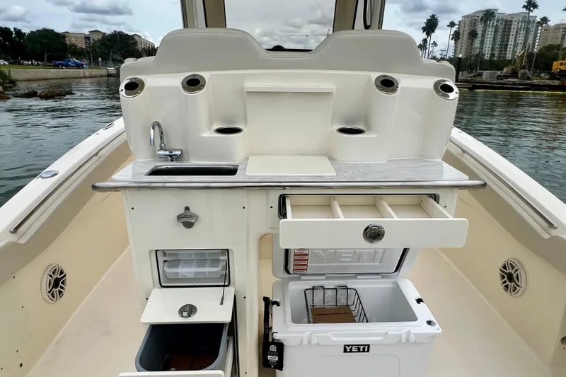  Yacht Photos Pics 2026 Scout 288 LXF boat with sink, storage, and Yeti cooler on deck.