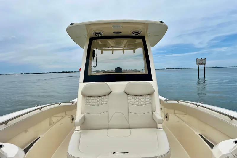  Yacht Photos Pics 2026 Scout 288 LXF boat on calm water, featuring luxurious seating and sleek design.