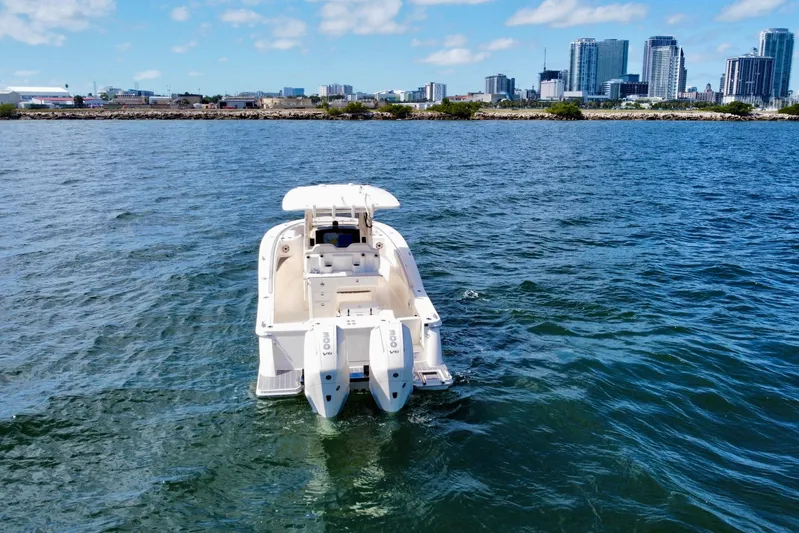  Yacht Photos Pics 2026 Scout 288 LXF boat on water with city skyline in background.