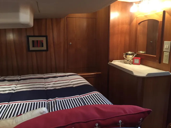 Sapphire Yacht Photos Pics 2007 Hunter 41 Deck Salon interior with striped bedding and wooden cabinetry.