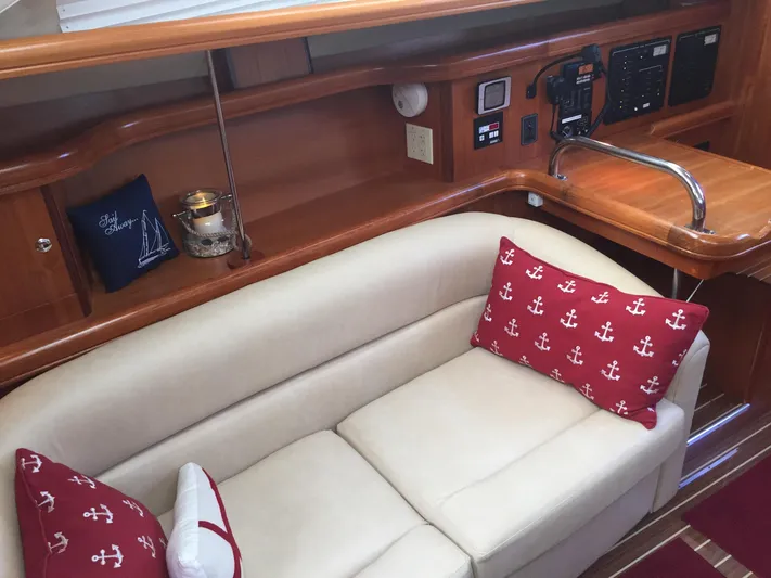 Sapphire Yacht Photos Pics 2007 Hunter 41 Deck Salon interior with beige sofa and nautical-themed cushions.