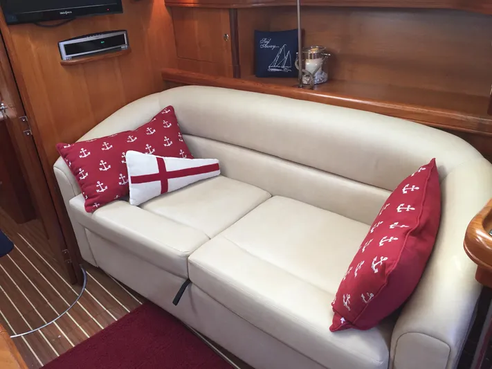 Sapphire Yacht Photos Pics Luxurious interior of 2007 Hunter 41 Deck Salon with beige sofa and nautical-themed pillows.