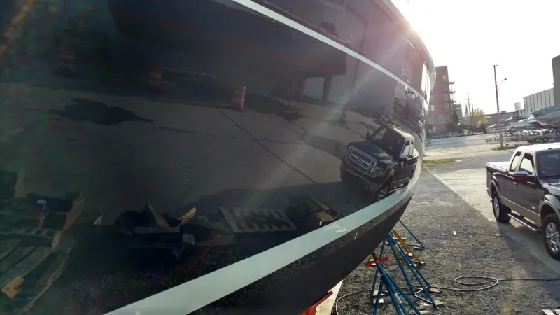 Sapphire Yacht Photos Pics 2007 Hunter 41 Deck Salon yacht hull reflecting nearby vehicles and surroundings.