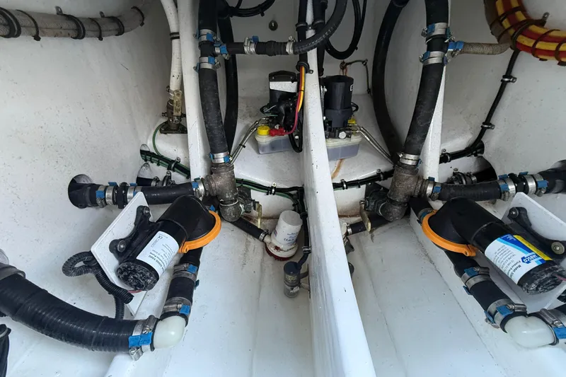  Yacht Photos Pics Engine compartment of 2023 Nor-Tech 340 Sport Open Center Console boat, showcasing intricate plumbing and wiring.