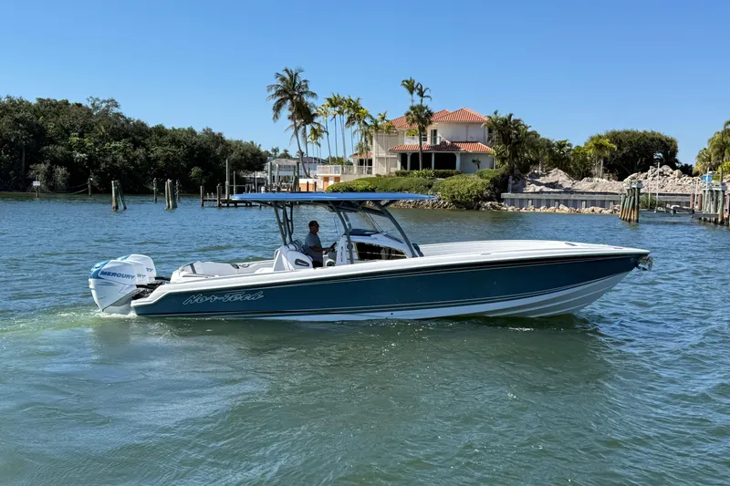  Yacht Photos Pics 2023 Nor-Tech 340 Sport Open Center Console boat cruising on a sunny day.