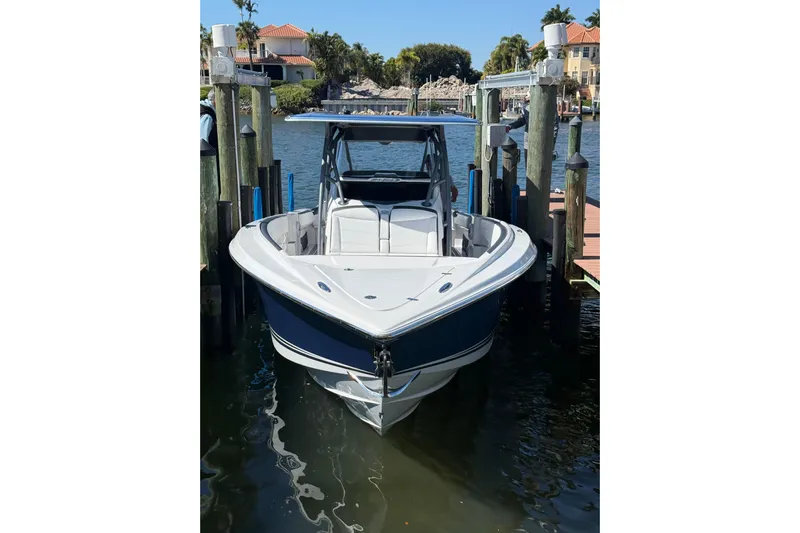  Yacht Photos Pics 2023 Nor-Tech 340 Sport Open Center Console docked in a scenic waterfront setting.