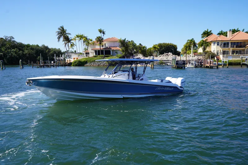  Yacht Photos Pics 2023 Nor-Tech 340 Sport Open Center Console boat on scenic waterfront.