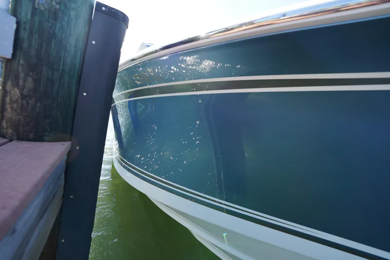  Yacht Photos Pics 2023 Nor-Tech 340 Sport Open Center Console docked, showcasing sleek blue hull design.