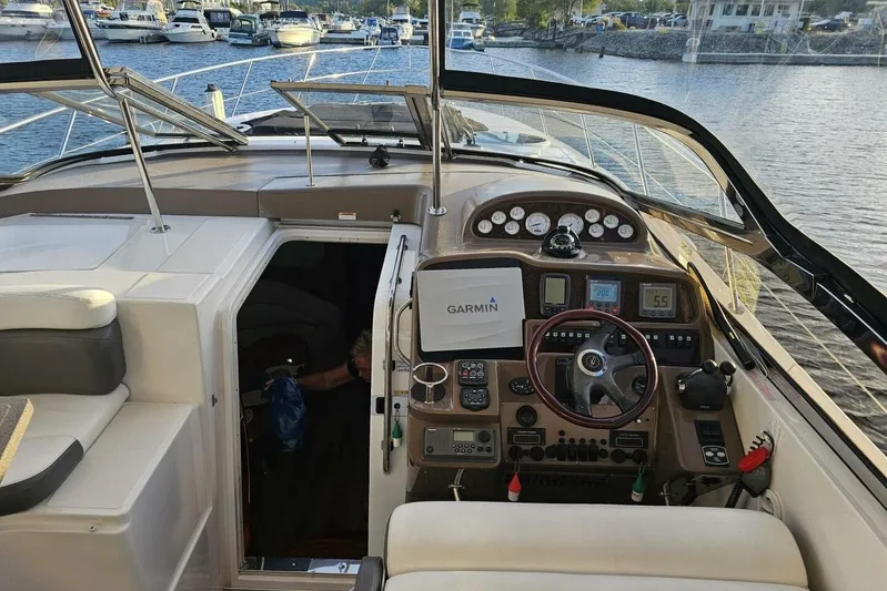  Yacht Photos Pics 2005 Regal Commodore 4260 yacht cockpit with Garmin navigation, docked at marina.