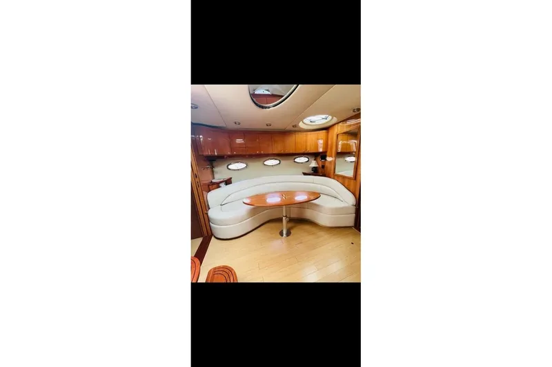  Yacht Photos Pics Luxurious interior of 2005 Regal Commodore 4260 yacht with elegant seating and wooden accents.