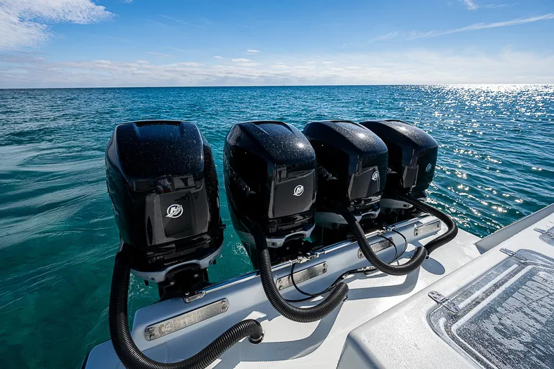  Yacht Photos Pics Four powerful outboard motors on a 2022 Contender 39 ST boat, cruising on open water.