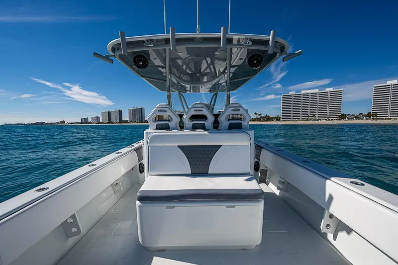  Yacht Photos Pics 2022 Contender 39 ST boat on water, with city skyline in background.