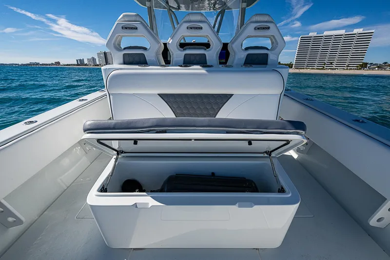  Yacht Photos Pics 2022 Contender 39 ST boat interior with open storage compartment, ocean view.