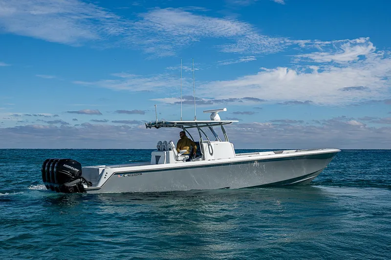  Yacht Photos Pics 2022 Contender 39 ST boat cruising on open water under a clear blue sky.