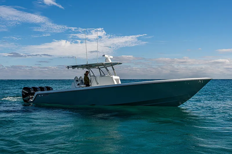  Yacht Photos Pics 2022 Contender 39 ST boat cruising on clear blue water under a bright sky.