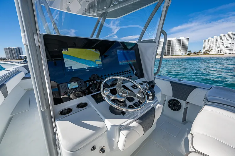 Yacht Photos Pics 2022 Contender 39 ST boat cockpit with modern navigation system and ocean view.