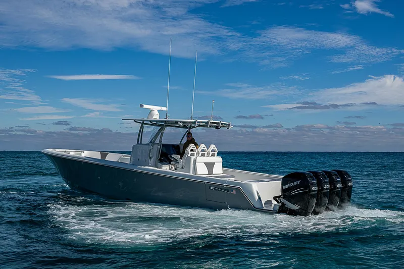  Yacht Photos Pics 2022 Contender 39 ST boat cruising on open water under a clear blue sky.