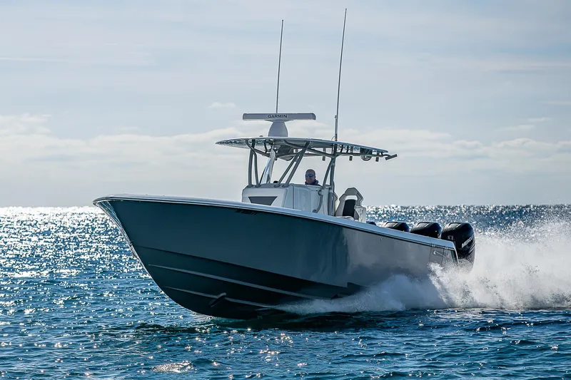  Yacht Photos Pics 2022 Contender 39 ST boat cruising on open water, creating a splash.