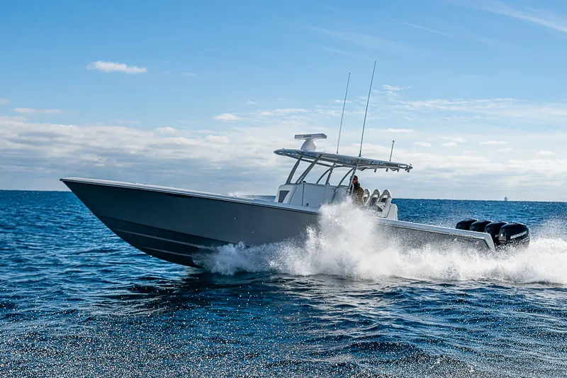  Yacht Photos Pics 2022 Contender 39 ST boat cruising on open water under clear blue sky.