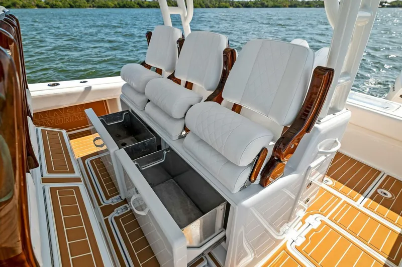  Yacht Photos Pics Luxury seating on 2022 Barker Boatworks 40 HPC, featuring white cushions and storage compartments.