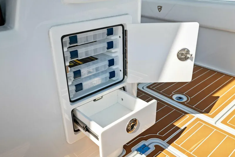  Yacht Photos Pics Open storage compartment on 2022 Barker Boatworks 40 HPC, featuring organized tackle boxes and drawer.