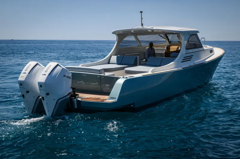 39 Outboard Yacht Photos Pics 2025 Toy 39 outboard boat cruising on clear blue ocean waters.