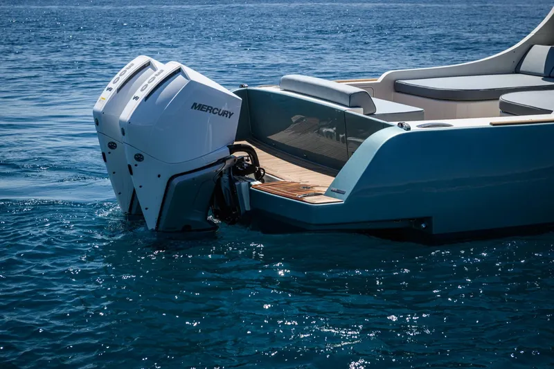 39 Outboard Yacht Photos Pics A modern boat with dual Mercury outboard engines on clear blue water.