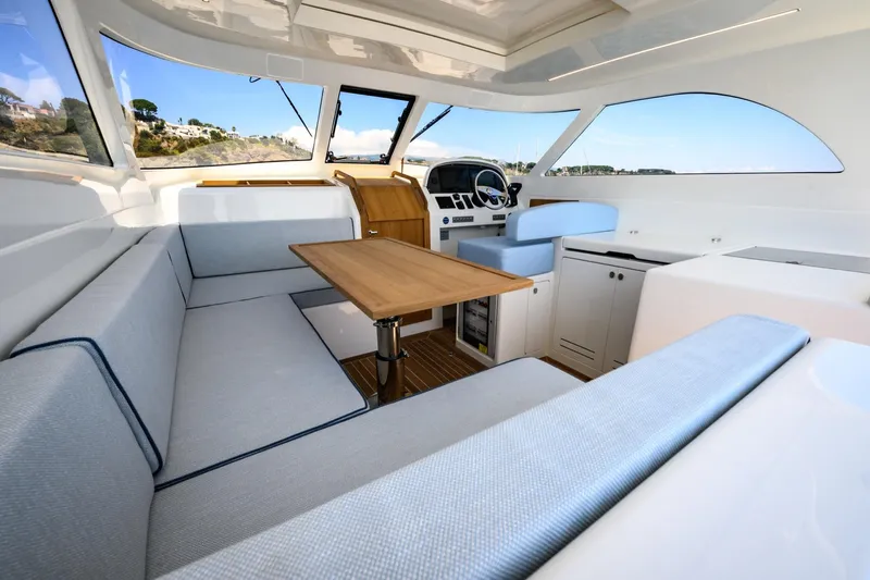 39 Outboard Yacht Photos Pics Luxurious interior of 2025 Toy 39 outboard boat with seating and table.