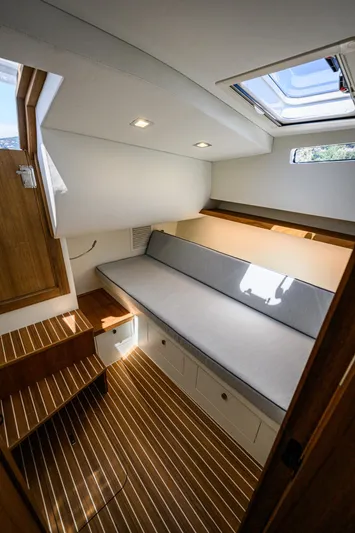 39 Outboard Yacht Photos Pics Modern interior of 2025 Toy 39 outboard boat with wooden flooring and skylight.