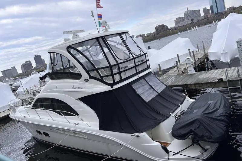  Yacht Photos Pics 2007 Sea Ray 520 Sedan Bridge yacht docked at a marina with city skyline.