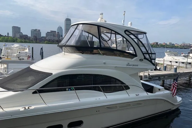  Yacht Photos Pics 2007 Sea Ray 520 Sedan Bridge yacht docked with city skyline in background.