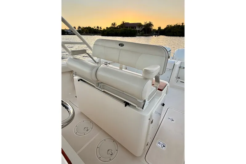  Yacht Photos Pics 2014 Pursuit S 280 Sport boat interior with seating, sunset view over water.