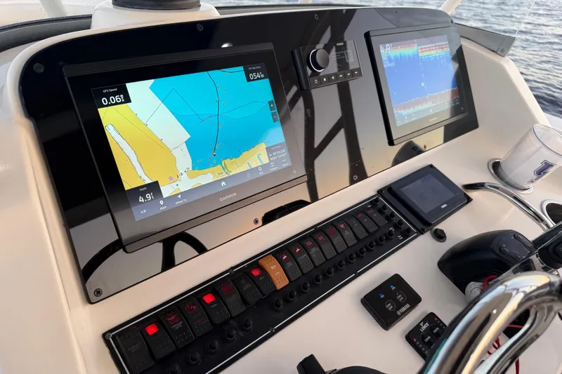  Yacht Photos Pics 2014 Pursuit S 280 Sport boat dashboard with navigation screens and controls.
