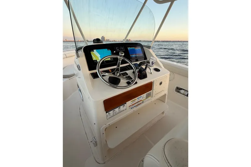  Yacht Photos Pics 2014 Pursuit S 280 Sport boat helm with steering wheel and navigation screens.