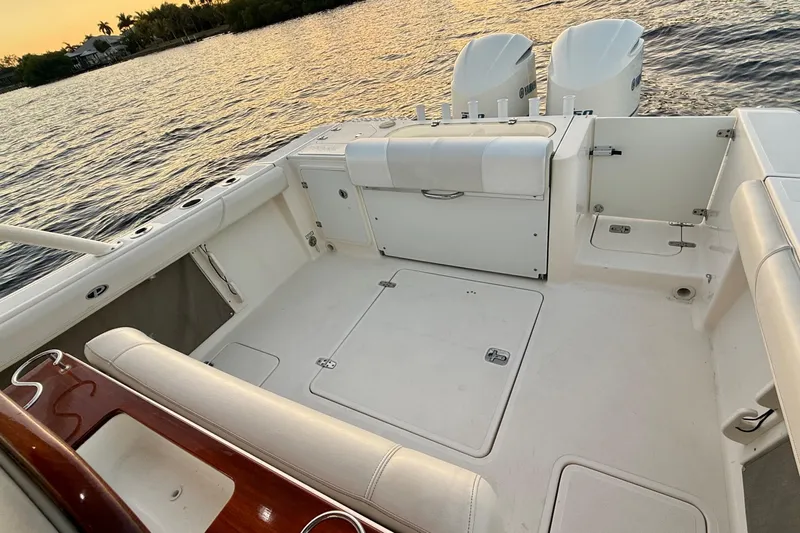  Yacht Photos Pics 2014 Pursuit S 280 Sport boat interior with dual engines, on calm water at sunset.