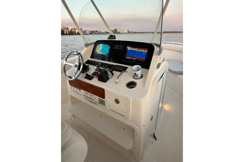 Yacht Photos Pics 2014 Pursuit S 280 Sport boat console with navigation screens and steering wheel.