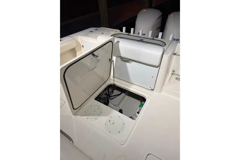  Yacht Photos Pics 2014 Pursuit S 280 Sport boat with open storage compartment and visible engine area.