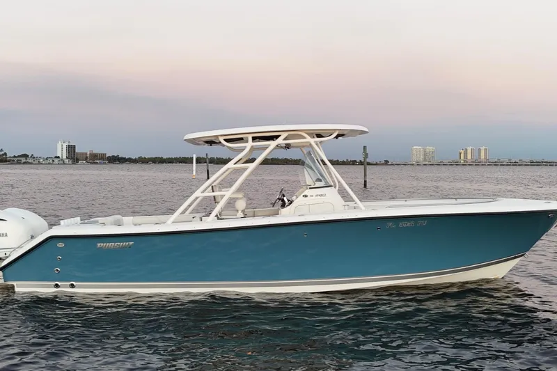  Yacht Photos Pics 2014 Pursuit S 280 Sport boat on calm water at sunset.