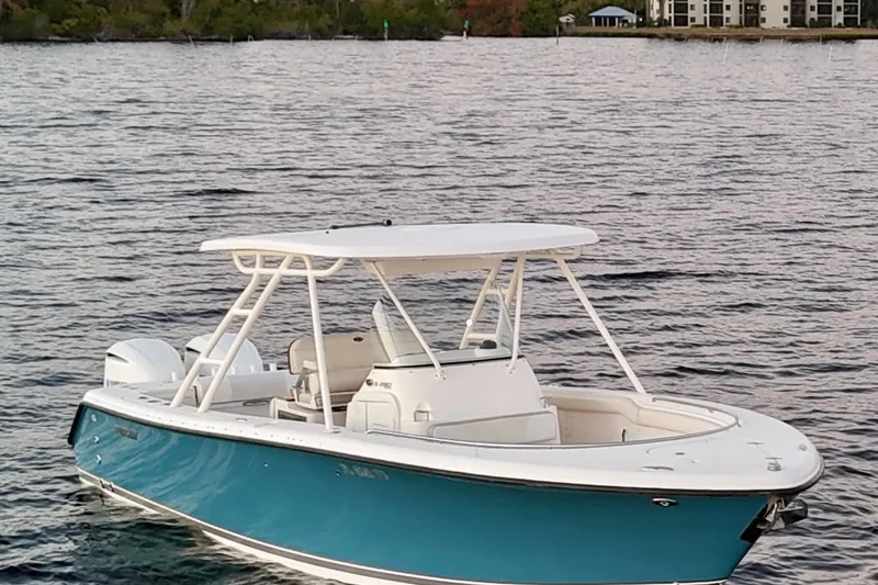 Yacht Photos Pics 2014 Pursuit S 280 Sport boat on calm water, featuring a sleek blue and white design.