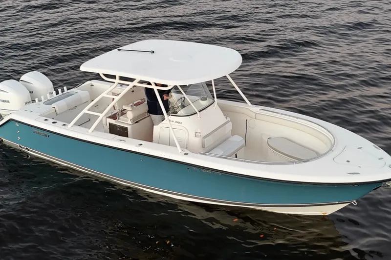  Yacht Photos Pics 2014 Pursuit S 280 Sport boat on water, featuring sleek design and dual engines.