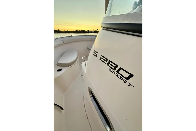  Yacht Photos Pics 2014 Pursuit S 280 Sport boat interior at sunset, showcasing sleek design and seating.