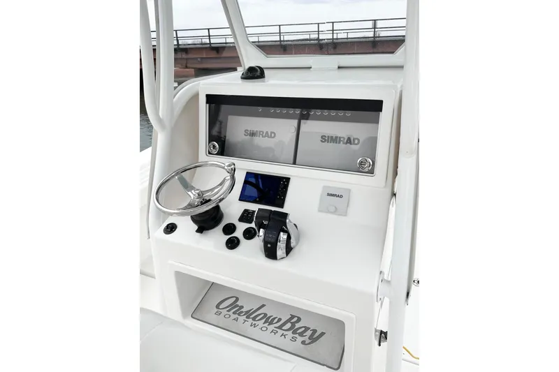  Yacht Photos Pics 2019 Onslow Bay 33 TE boat console with Simrad electronics and steering wheel.