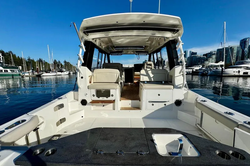 Days Ahead Yacht Photos Pics 2022 Boston Whaler 405 Conquest boat docked in a marina, showcasing spacious deck and seating.